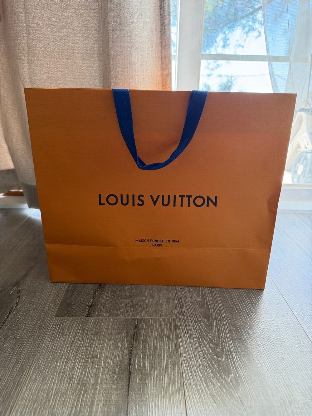 Louis Vuitton Orange Bag with Blue Handles and Logo